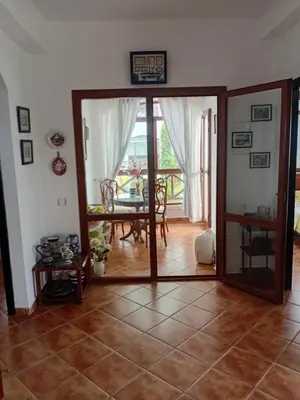 a living room with a glass door and a table at Chic appartement costa cabo in Oulad Akkou
