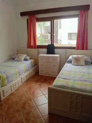 a bedroom with two beds and a window at Chic appartement costa cabo in Oulad Akkou