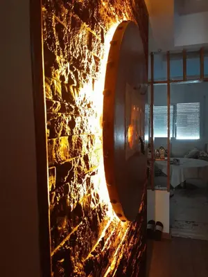 a stone wall in a room with a fire at résidence ichraka in Oulad Akkou