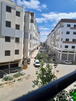 a view of a street with tall buildings at résidence ichraka in Oulad Akkou