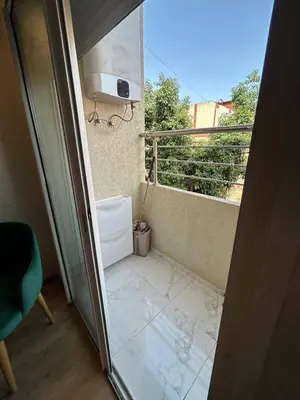an open door to a balcony with a view of a room at résidence ichraka in Oulad Akkou