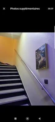 a photograph of a staircase with a picture on the wall at تجزئة الباهية in Meknès