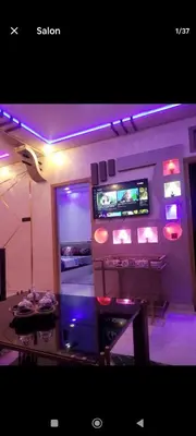 a room with a table and a tv on a wall at تجزئة الباهية in Meknès