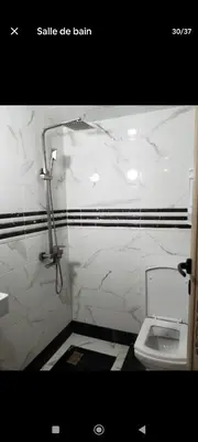 a bathroom with a white toilet in a stall at تجزئة الباهية in Meknès