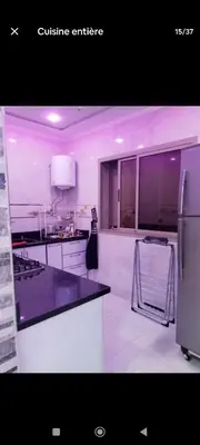 a kitchen with a counter top and a refrigerator at تجزئة الباهية in Meknès