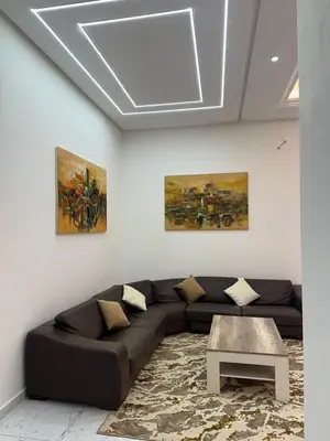 a living room with a couch and a table at Taghazout Bay Villa AMDA in Oulad Akkou