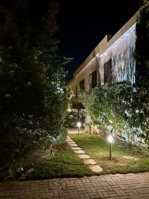 a building at night with lights in front of it at Taghazout Bay Villa AMDA in Oulad Akkou