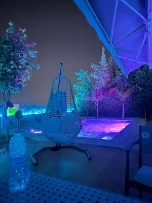 a bird cage sitting on top of a table with lights at Taghazout Bay Villa AMDA in Oulad Akkou
