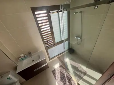 a bathroom with a shower and a sink and a toilet at Taghazout Bay Villa AMDA in Oulad Akkou