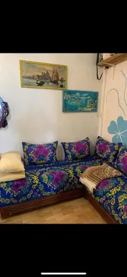 a living room with a couch with colorful pillows at Apartment a louer sur targha tetouan in Oulad Akkou
