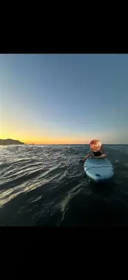 a blue surfboard in the water on the ocean at Apartment a louer sur targha tetouan in Oulad Akkou