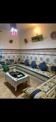 a living room with couches and a table in a room at Apartment a louer sur targha tetouan in Oulad Akkou