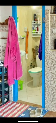 a bathroom with a pink towel hanging on the door at Apartment a louer sur targha tetouan in Oulad Akkou