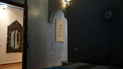 a bedroom with a bed and a mirror on the wall at Villa Zazate in Ouarzazate
