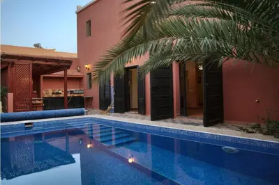 a swimming pool in front of a house at Villa Zazate in Ouarzazate