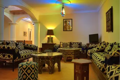 a living room with couches and a table at Villa Zazate in Ouarzazate