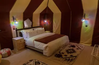 a bedroom with a large bed in a tent at Azul desert camp in Merzouga