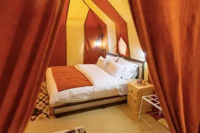 a bedroom with a bed with a canopy at Azul desert camp in Merzouga