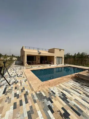 a large swimming pool in front of a house at Villa Azoul in Tiguemmi n Oumzil et Tnine