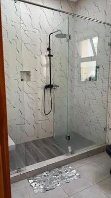a shower with a glass door in a bathroom at Villa Azoul in Tiguemmi n Oumzil et Tnine