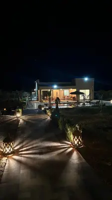a building with lights in front of it at night at Villa Azoul in Tiguemmi n Oumzil et Tnine