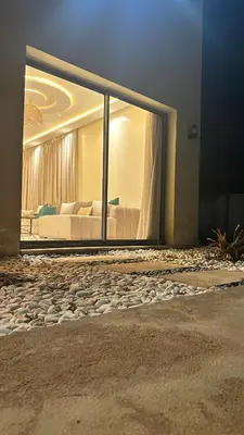 a bedroom with a bed and a large glass window at Villa Azoul in Tiguemmi n Oumzil et Tnine