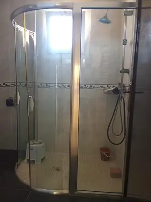 a shower with a glass door in a bathroom at appartement duplex a saidia in Oulad Akkou