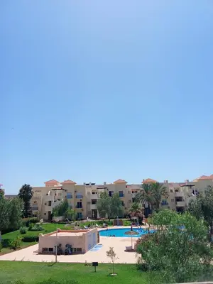 a resort with a swimming pool and some buildings at appartement duplex a saidia in Oulad Akkou