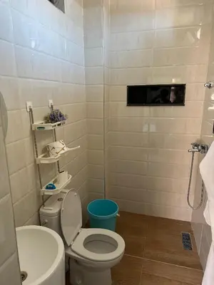 a bathroom with a toilet and a sink at villas par jour in Amezrou