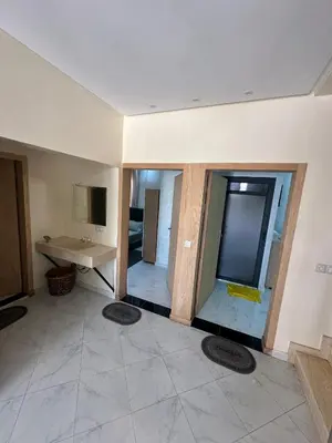 a large bathroom with a sink and a mirror at villas par jour in Amezrou