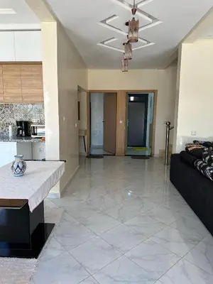 a large living room with a couch and a kitchen at villas par jour in Amezrou
