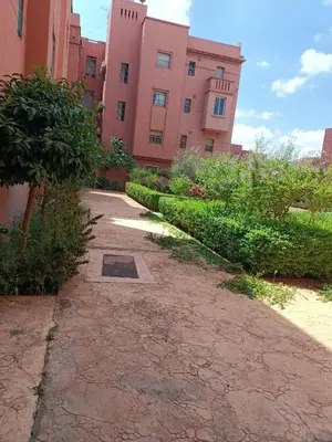 a walkway in front of a pink building at Chwiter Marrakech in Chouiter