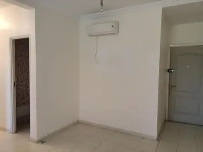 an empty room with a white wall and a door at Chwiter Marrakech in Chouiter