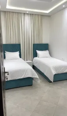 two beds sitting next to each other in a room at Casa Arabica in Oulad Akkou