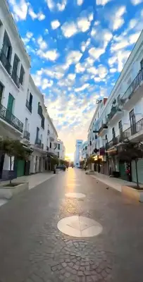an empty street with buildings and a cloudy sky at Casa Arabica in Oulad Akkou