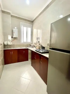 a large kitchen with a stainless steel refrigerator at The White House Tetouan in Oulad Akkou