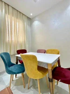 a dining room with a white table and chairs at The White House Tetouan in Oulad Akkou