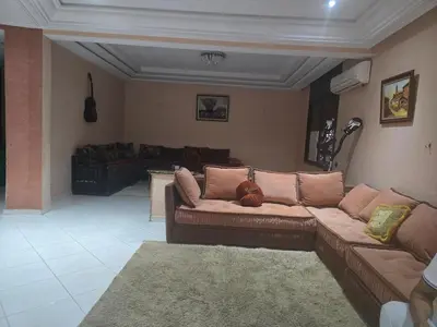 a living room with a couch and a table at Appartement spacieux au cœur de Hamria in Meknès