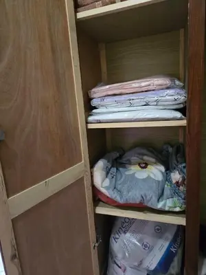 a cupboard with some clothes and towels in it at Appartement spacieux au cœur de Hamria in Meknès
