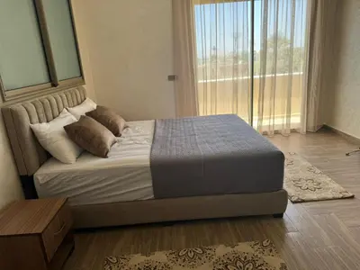 a bed in a bedroom with a large window at villas d'or in Marrakech