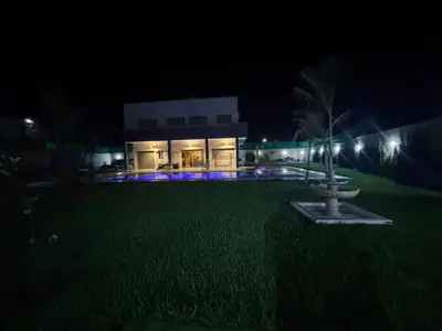 a building with a fountain in the yard at night at villas d'or in Marrakech