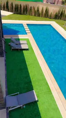 an overhead view of a swimming pool with two purple chairs at villas d'or in Marrakech