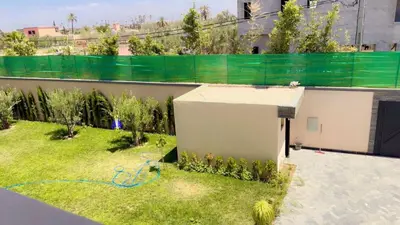 a backyard with a small building in the grass at villas d'or in Marrakech