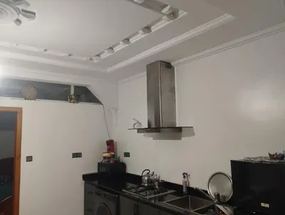a kitchen with a sink and a stove at Super appartement quartier paisible proches toutes commodités in Azrou