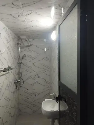 a bathroom with a toilet and a sink and a mirror at Super appartement quartier paisible proches toutes commodités in Azrou