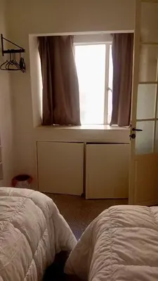 a bedroom with a bed and a window at Á 800m de la Marina Bay Tanger in Oulad Akkou