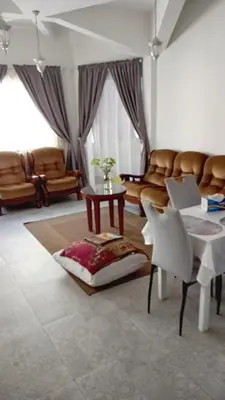 a living room with a couch and a table with a laptop at Á 800m de la Marina Bay Tanger in Oulad Akkou