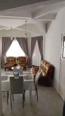 a living room with a couch and a table at Á 800m de la Marina Bay Tanger in Oulad Akkou