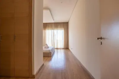 an empty room with a bed and a window at Modern 3BR with High Amenities and Stylish Decor in Oulad Akkou