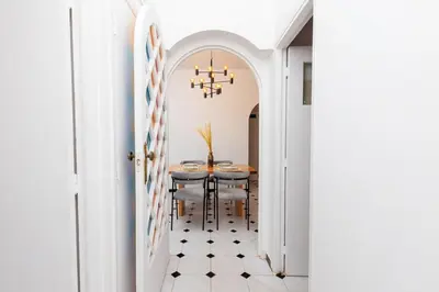 a dining room with a table and a chandelier at Modern Elegance 2BR in the Heart of Agdal in Oulad Akkou